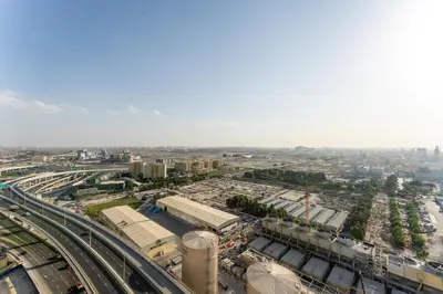 an overhead view of a city with trains and highways at Cozy Marina Studio with Partial Sea View in Dubai