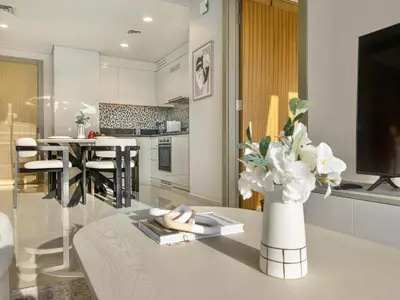 a living room with a vase of flowers on a table at Aykon Luxury Sky Collection Suites with Sea View by HSHOME in Dubai