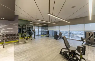 a gym with treadmills and exercise equipment in a building at Aykon Luxury Sky Collection Suites with Sea View by HSHOME in Dubai