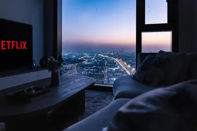 a living room with a view of a city from a window at Aykon Luxury Sky Collection Suites with Sea View by HSHOME in Dubai