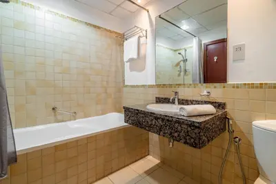 a bathroom with a sink and a tub and a toilet at GuestReady - Enchanting retreat in JBR in Dubai