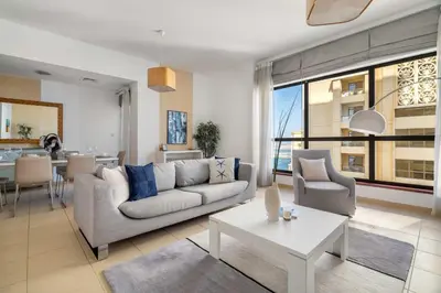 a living room with a couch and a table at GuestReady - Enchanting retreat in JBR in Dubai