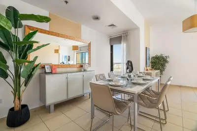 a kitchen and dining room with a table and chairs at GuestReady - Enchanting retreat in JBR in Dubai