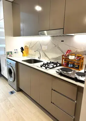 a kitchen with a sink and a stove at 8min from Downtown in Dubai
