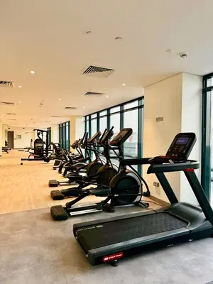 a row of treadmills in a gym at 8min from Downtown in Dubai