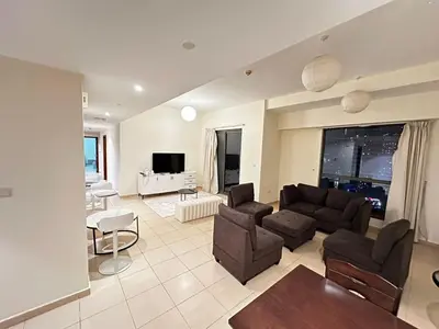 a living room with a couch and chairs and a tv at HOT MASTER BED ROOM - JBR WALK Marina in Dubai