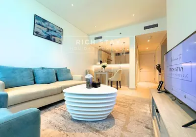 a living room with a couch and a table at Seven Palm Escape 1BR in Palm Jumeirah in Dubai