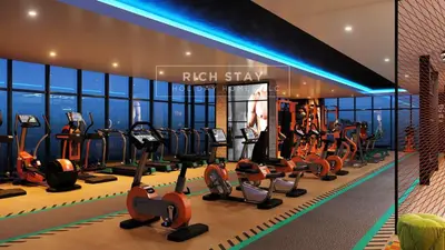 a gym with a row of treadmills and ellipticals at Seven Palm Escape 1BR in Palm Jumeirah in Dubai