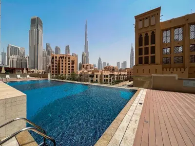 a swimming pool on top of a building with a city skyline at HAVN - 1 Bedroom in Downtown, Burj Khalifa View in Dubai