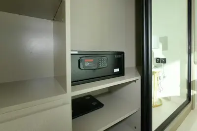 a microwave oven sitting in a cabinet in a room at Burj Khalifa Poolview 1BR Apartment for 4 people in Dubai