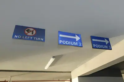 two blue signs on the ceiling of a building at Burj Khalifa Poolview 1BR Apartment for 4 people in Dubai