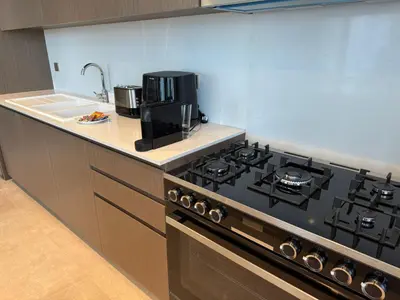 a kitchen with a black stove and a sink at Luxury Grande Downtown Full Burj khalifa Views in Dubai