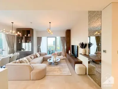 a living room with a couch and a tv at Luxury Grande Downtown Full Burj khalifa Views in Dubai