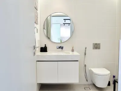 a white bathroom with a sink and a mirror at Beachfront Townhouse SEA BREEZE in Dubai