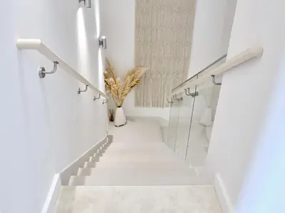 a staircase in a white room with white walls at Beachfront Townhouse SEA BREEZE in Dubai