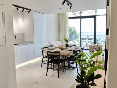 a kitchen and dining room with a table and chairs at Beachfront Townhouse SEA BREEZE in Dubai