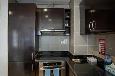 a kitchen with a stove and a refrigerator at Private Beach - 1-BHK - Palm Jumeirah - Resort in Dubai