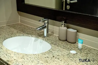 a bathroom counter with a sink and a mirror at Private Beach - 1-BHK - Palm Jumeirah - Resort in Dubai