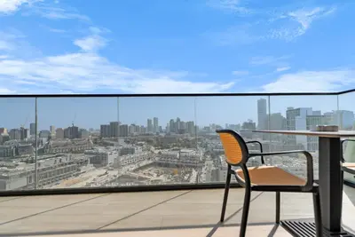 a chair on a balcony with a view of a city at Magnificent - New Modern 1BR in Binghatti Heights in Dubai