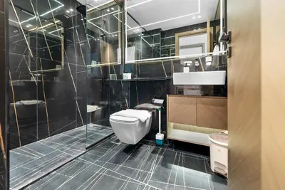 a bathroom with a toilet and a shower at Magnificent - New Modern 1BR in Binghatti Heights in Dubai