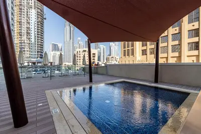 a swimming pool on the roof of a building at 2BR plus Maid Bellevue Tower 1, Burj Khalifa View in Dubai