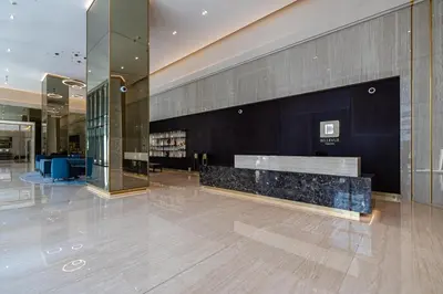 a lobby with a bench in the middle of a building at 2BR plus Maid Bellevue Tower 1, Burj Khalifa View in Dubai