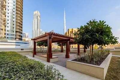 a wooden pavilion in a city with tall buildings at 2BR plus Maid Bellevue Tower 1, Burj Khalifa View in Dubai