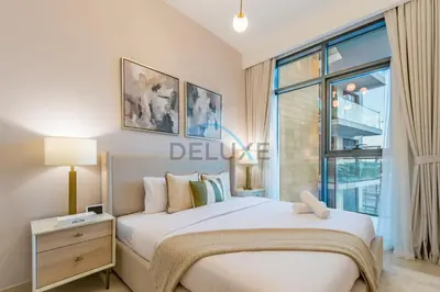 a bedroom with a large bed and a window at Contemporary 2BR in Azizi Park Avenue, Nad Al Sheba by Deluxe Holiday Homes in Dubai