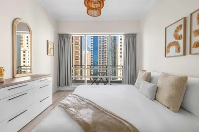 a bedroom with a white bed and a large window at Superb Marina Views I Sleeps 5 in Dubai