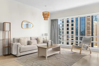 a living room with a couch and a table at Superb Marina Views I Sleeps 5 in Dubai