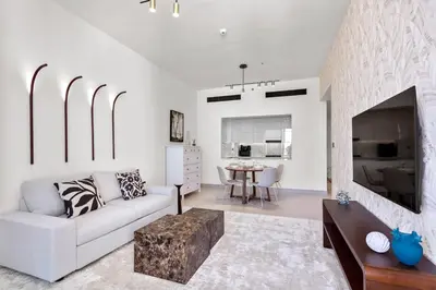 a living room with a couch and a table at Stylish 1 Bedroom in Binghatti Lavender JVC in Dubai