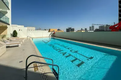 a swimming pool on the roof of a building at Stylish 1 Bedroom in Binghatti Lavender JVC in Dubai