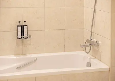 a bathroom with a bath tub with two bottles on it at Stunning 2 BR Burj Khalifa Fountain Views in Dubai