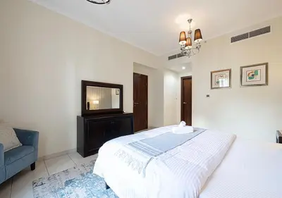 a bedroom with a bed and a television in it at Stunning 2 BR Burj Khalifa Fountain Views in Dubai