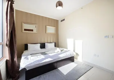 a bedroom with a bed in a room at Stunning 2 BR Burj Khalifa Fountain Views in Dubai