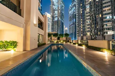 a swimming pool in the middle of a building with tall buildings at Westminster ACT1 ACT2 Burj Khalifa in Dubai