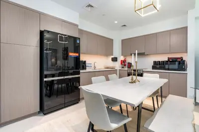 a kitchen and dining room with a white table and chairs at Westminster ACT1 ACT2 Burj Khalifa in Dubai
