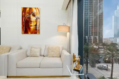 a living room with a couch and a large window at Westminster ACT1 ACT2 Burj Khalifa in Dubai