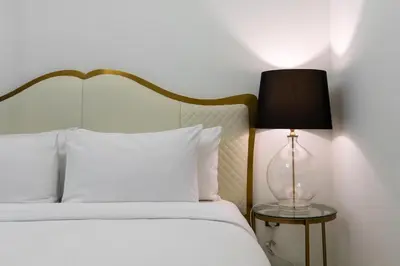 a bedroom with a bed with a lamp on a table at Westminster ACT1 ACT2 Burj Khalifa in Dubai