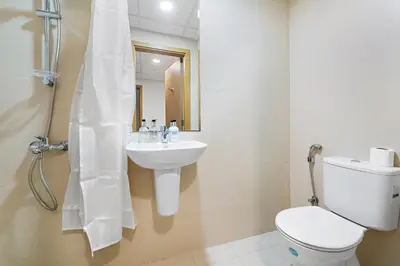 a bathroom with a toilet and a sink at 2BR plus Maid Bellevue Tower 1, Burj Khalifa View in Dubai