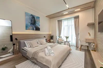 a bedroom with a large bed with two towels on it at Heart of Dubai in Dubai