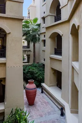 a large vase sitting in the courtyard of a building at Heart of Dubai in Dubai