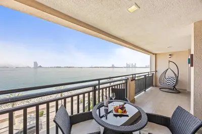 a balcony with a view of the water at Burj View Luxury 1BR - Full Sea View Private Beach - Anantara Palm in Dubai