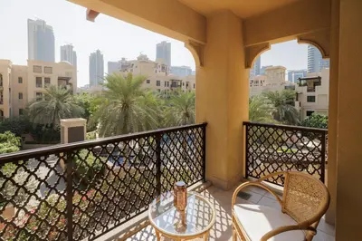 a balcony with a table and chairs on a balcony at 1001 Nights - Luxury 1-BR apartment near Burj in Dubai