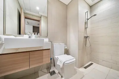 a bathroom with a toilet and a sink and a shower at Studio Azizi Riviera 35, Community View in Dubai