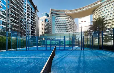 a tennis court in a city with tall buildings at Palm Jumeirah - Private Beach & Free Infinity Pool in Dubai