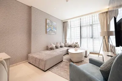 a living room with a couch and a table at Palm Jumeirah - Private Beach & Free Infinity Pool in Dubai