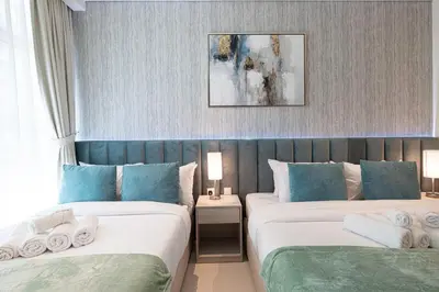 two beds in a room with blue and white at Palm Jumeirah - Private Beach & Free Infinity Pool in Dubai