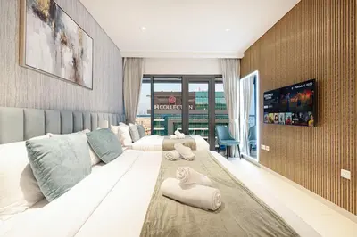 a hotel room with a large bed with towels on it at Palm Jumeirah - Private Beach & Free Infinity Pool in Dubai