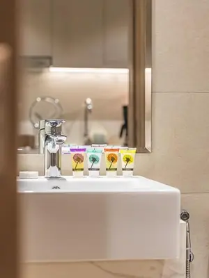 a bathroom sink with four toothbrushes and a mirror at Tranquil Studio Getaway in Meydan City in Dubai